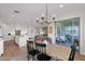 Open concept kitchen and dining area filled with natural light from sliding glass door at 9734 E Spiral Ave, Mesa, AZ 85212