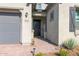 Inviting front entrance with a gray front door, brick walkway, and desert landscaping at 9734 E Spiral Ave, Mesa, AZ 85212