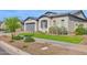 Beautiful single-story home featuring lush green lawn, desert landscaping, and a two car garage at 9734 E Spiral Ave, Mesa, AZ 85212