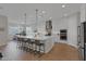 A bright kitchen features a large island with bar stools and modern stainless steel appliances at 9734 E Spiral Ave, Mesa, AZ 85212