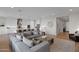 Open-concept living area with modern gray sofa, connected to a kitchen with a large island at 9734 E Spiral Ave, Mesa, AZ 85212