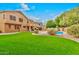 Expansive backyard featuring lush green grass and a refreshing pool, perfect for outdoor enjoyment at 9758 E Monterey Ave, Mesa, AZ 85209