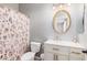 Stylish bathroom featuring floral shower curtain, gold hardware, and a modern oval mirror at 9758 E Monterey Ave, Mesa, AZ 85209