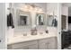 Bright bathroom featuring double vanity, decorative mirrors, and modern fixtures at 9758 E Monterey Ave, Mesa, AZ 85209