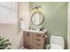 Well-lit bathroom with a wooden vanity, round mirror, and stylish fixtures at 9758 E Monterey Ave, Mesa, AZ 85209