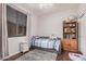 Cozy bedroom featuring neutral colors, a twin bed, and a wooden bookshelf at 9758 E Monterey Ave, Mesa, AZ 85209