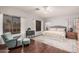 Well-lit primary bedroom features a cozy seating area and hardwood floors at 9758 E Monterey Ave, Mesa, AZ 85209