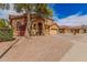 Exterior elevation featuring manicured front yard, desert landscaping, and two-car garage at 9758 E Monterey Ave, Mesa, AZ 85209