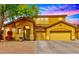 Charming home exterior with a well-maintained yard, three-car garage and welcoming entrance at 9758 E Monterey Ave, Mesa, AZ 85209