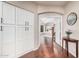 Hallway featuring ample storage cabinets and a glimpse into the spacious bedroom at 9758 E Monterey Ave, Mesa, AZ 85209