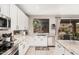 Open kitchen featuring stainless steel appliances, granite counters, and backyard views at 9758 E Monterey Ave, Mesa, AZ 85209