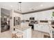 Spacious kitchen featuring white cabinets, stainless steel appliances, and a granite island at 9758 E Monterey Ave, Mesa, AZ 85209