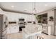 Modern kitchen with white cabinets, stainless appliances, granite counters, and bright natural light at 9758 E Monterey Ave, Mesa, AZ 85209