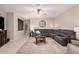 Comfortable living room with a large sectional sofa, ceiling fan, and large windows at 9758 E Monterey Ave, Mesa, AZ 85209