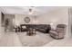 Relaxing living room with large sofa, modern ceiling fan, and neutral decor at 9758 E Monterey Ave, Mesa, AZ 85209