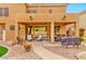 Cozy covered patio with comfortable seating and a view of the landscaped backyard and pool at 9758 E Monterey Ave, Mesa, AZ 85209