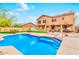 Inviting backyard pool with a view of the home's exterior and covered patio seating area at 9758 E Monterey Ave, Mesa, AZ 85209