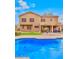 A sparkling pool in the backyard provides a serene escape with a backdrop of the home's architecture at 9758 E Monterey Ave, Mesa, AZ 85209
