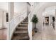 Elegant staircase featuring a curved design and leads to the upper level of the home at 9758 E Monterey Ave, Mesa, AZ 85209