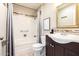 Well-maintained bathroom with a shower-tub combination, tiled accents, and a stylish vanity area at 10547 W Coggins Dr, Sun City, AZ 85351