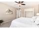 Neutral bedroom featuring a comfortable bed, soft carpet, closet, and an eye-catching abstract print at 10547 W Coggins Dr, Sun City, AZ 85351