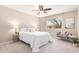 Relaxing bedroom with a comfortable bed, soft lighting, and a window offering a bright outdoor view at 10547 W Coggins Dr, Sun City, AZ 85351