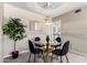 Cozy dining area with modern light fixture, glass table, and comfortable seating at 10547 W Coggins Dr, Sun City, AZ 85351