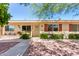 Charming single-story home featuring desert landscaping, light-colored siding, and bright awnings at 10547 W Coggins Dr, Sun City, AZ 85351
