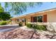 Inviting one-story home features desert landscaping, light-colored siding, and bright awnings at 10547 W Coggins Dr, Sun City, AZ 85351