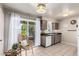Bright kitchen boasts natural light, a stainless steel sink, and seating near sliding glass doors at 10547 W Coggins Dr, Sun City, AZ 85351