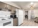 Fully equipped kitchen featuring modern appliances and neutral cabinetry adjacent to the dining area at 10547 W Coggins Dr, Sun City, AZ 85351