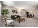 Comfortable living room featuring neutral walls, plush carpet, and stylish furnishings at 10547 W Coggins Dr, Sun City, AZ 85351