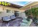 Cozy covered patio with comfortable seating and charming garden details, perfect for outdoor relaxation and entertaining at 10547 W Coggins Dr, Sun City, AZ 85351