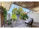 Inviting patio featuring seating surrounded by vibrant greenery and colorful flowers at 10547 W Coggins Dr, Sun City, AZ 85351