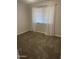 Bright bedroom featuring plush carpet and window with sheer white curtains at 1132 E 9Th Pl, Casa Grande, AZ 85122