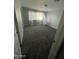 A freshly painted bedroom features neutral walls, carpeting, a large window, and white trim at 1132 E 9Th Pl, Casa Grande, AZ 85122