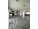 A spacious open floor plan shows the kitchen and living room with the attractive wood-look floors at 1132 E 9Th Pl, Casa Grande, AZ 85122