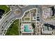 Aerial view of a community pool, playground, and circular street design with landscaping at 1255 N Arizona Ave # 1043, Chandler, AZ 85225
