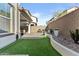 A well-kept backyard with artificial turf, gravel beds, brick-paved patio and outdoor seating is perfect for entertaining at 1255 N Arizona Ave # 1043, Chandler, AZ 85225