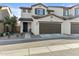 Charming two-story home with a dark brown garage door and a covered entryway at 1255 N Arizona Ave # 1043, Chandler, AZ 85225