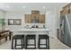 Kitchen with stainless steel appliances, a center island, and stylish bar stools at 1255 N Arizona Ave # 1043, Chandler, AZ 85225