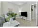 Cozy living room features a comfortable gray sofa and a television with a decorative vase of flowers at 1255 N Arizona Ave # 1043, Chandler, AZ 85225