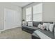 Inviting living room with a comfortable gray sofa, plush pillows, and abundant natural light from the windows at 1255 N Arizona Ave # 1043, Chandler, AZ 85225