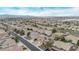 Expansive aerial view of a neighborhood showcasing homes with solar panels, with a backdrop of mountains and city views at 12910 W Tuckey Ln, Glendale, AZ 85307
