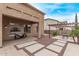 Expansive backyard featuring a covered patio, pergola and decorative stone landscaping perfect for entertaining at 12910 W Tuckey Ln, Glendale, AZ 85307