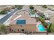 Inviting backyard with a sparkling pool, artificial grass, desert landscaping, and covered patio at 12910 W Tuckey Ln, Glendale, AZ 85307