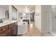 Well-lit bathroom boasting dual sinks, tub, tile floors, and vanity space at 12910 W Tuckey Ln, Glendale, AZ 85307