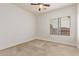 Neutral bedroom with ceiling fan, window, and carpeted floors at 12910 W Tuckey Ln, Glendale, AZ 85307