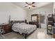 Bedroom with wood-look floors, ceiling fan, and furnished with dark wood furniture at 12910 W Tuckey Ln, Glendale, AZ 85307