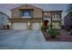 Inviting two-story home boasting a spacious driveway, desert landscaping, and a charming red front door at 12910 W Tuckey Ln, Glendale, AZ 85307
